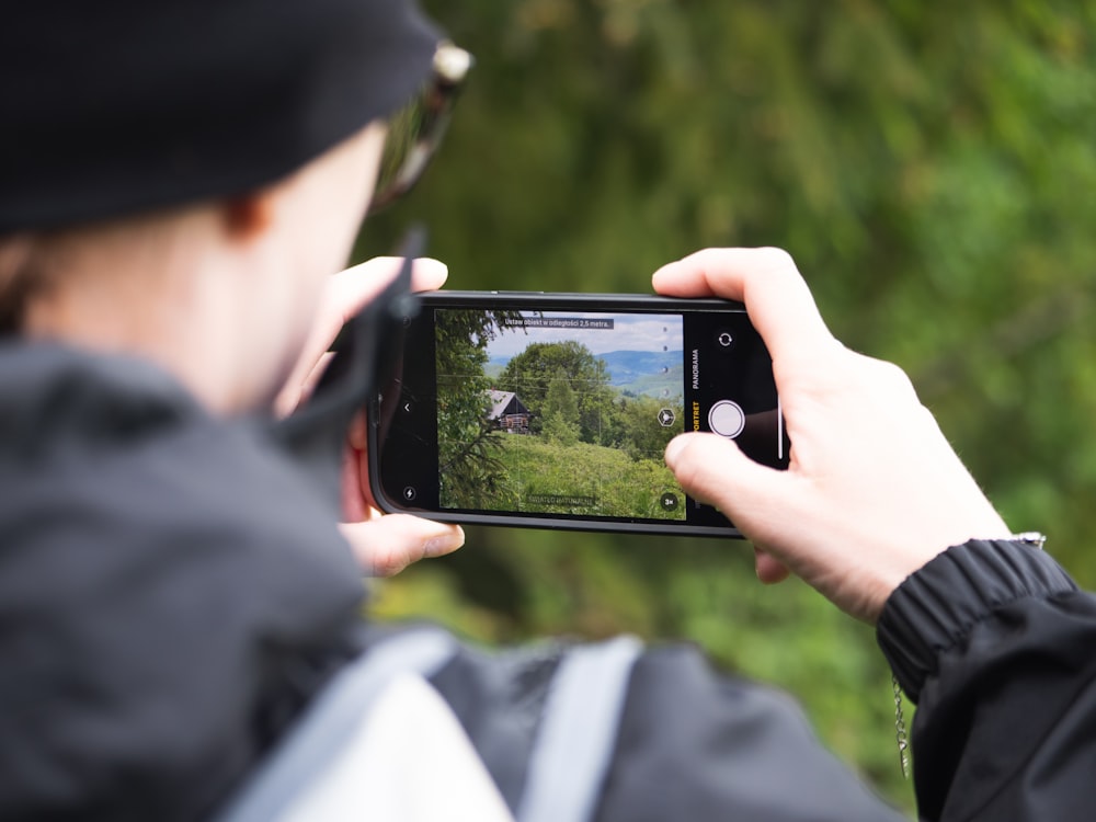 a person taking a picture with a cell phone