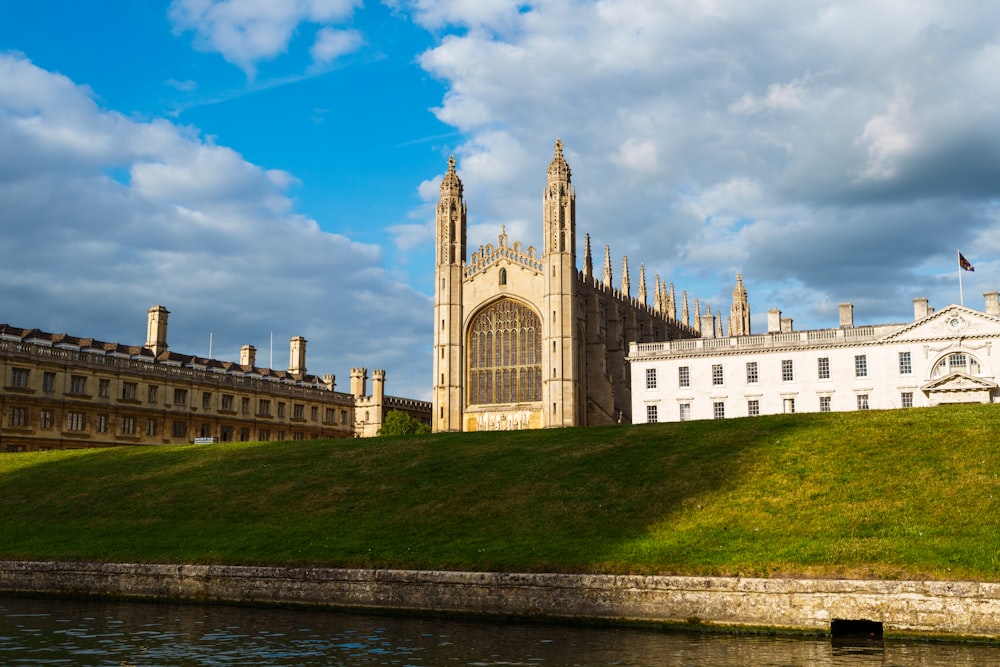 a large building sitting on top of a lush green hillside