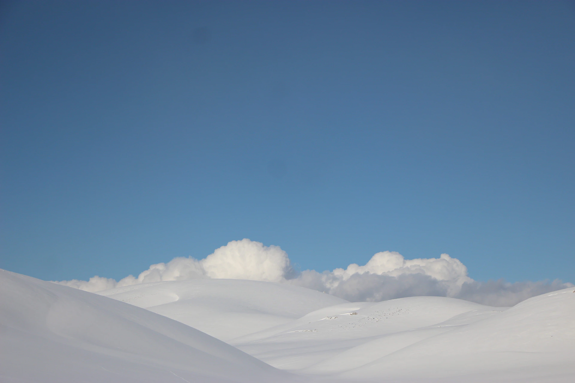 a person riding skis on top of a snow covered slope