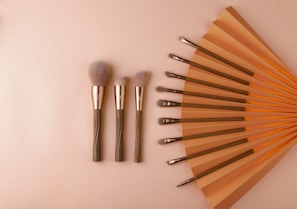 a collection of makeup brushes sitting on top of a table