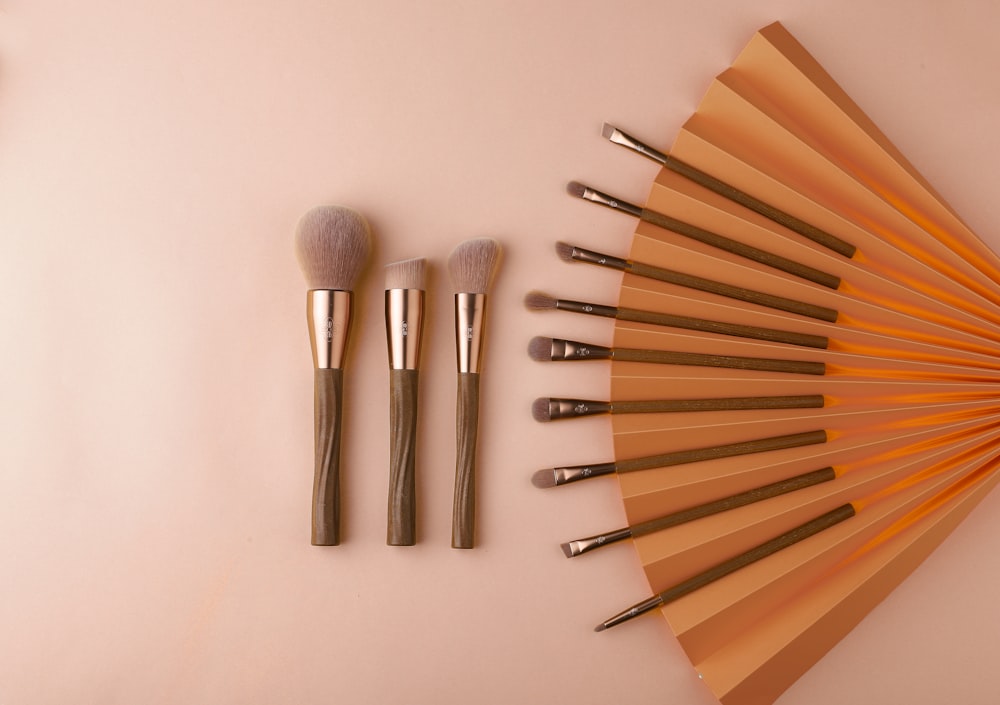 a collection of makeup brushes sitting on top of a table