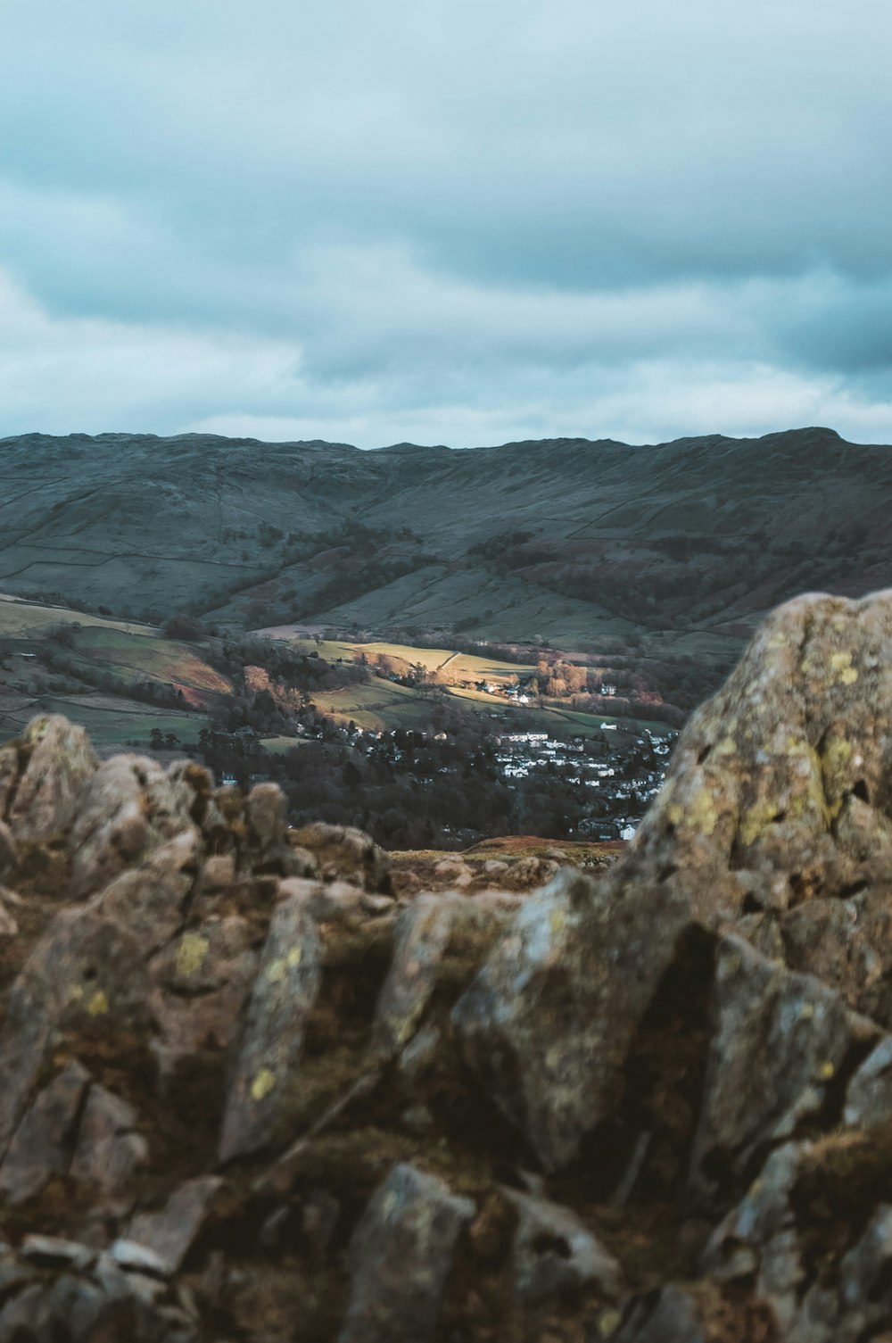 a view of a mountain range from a rocky outcropping