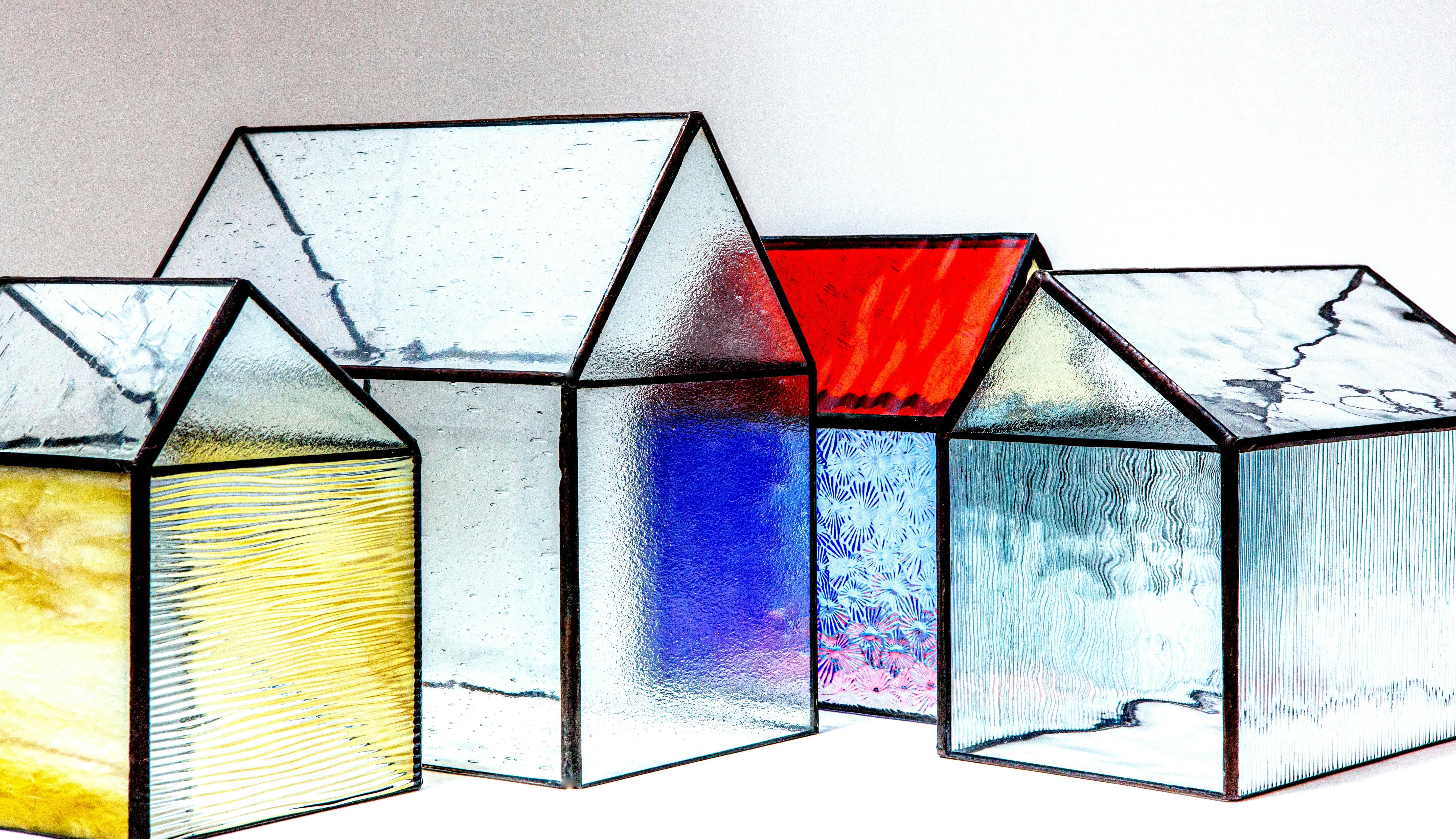 a group of three glass houses sitting next to each other