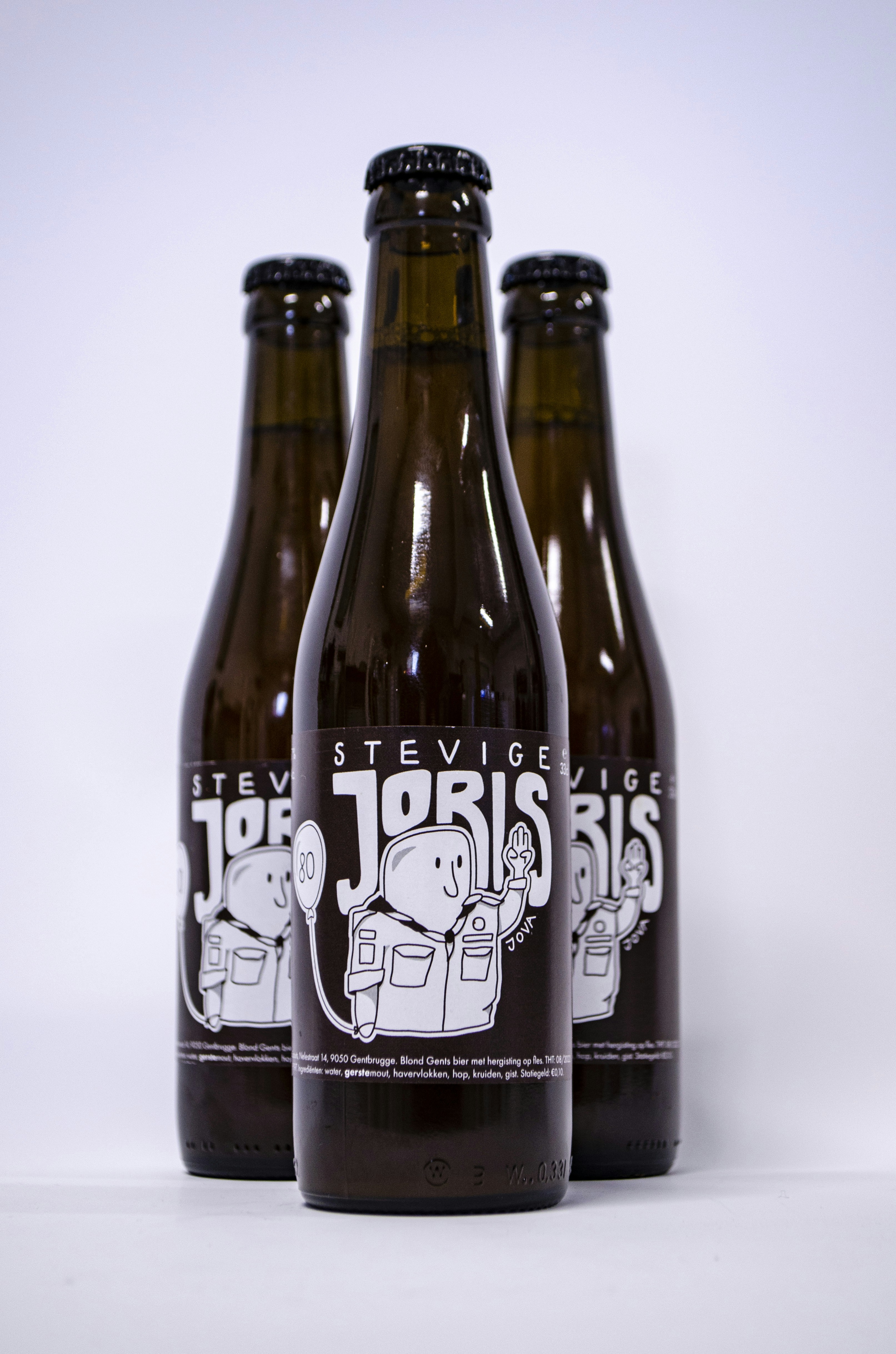 Three bottles of beer sitting next to each other photo Free Beer