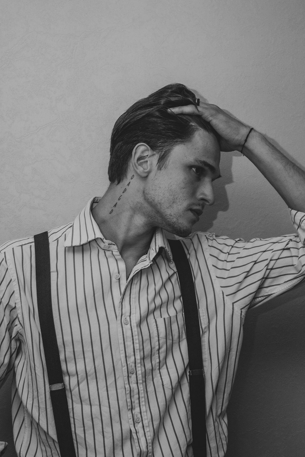 a man in suspenders and a striped shirt