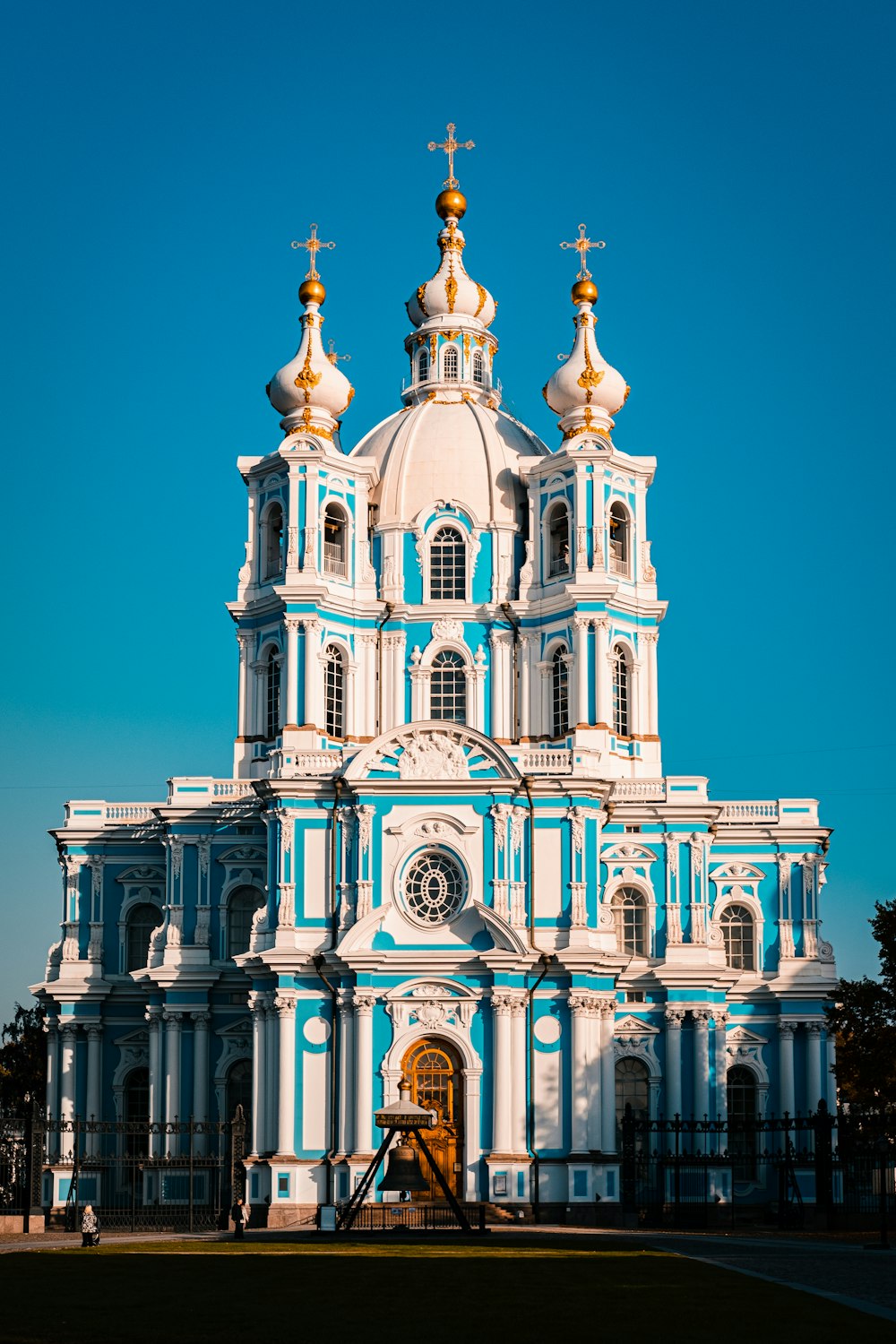 a large white and blue church with gold domes