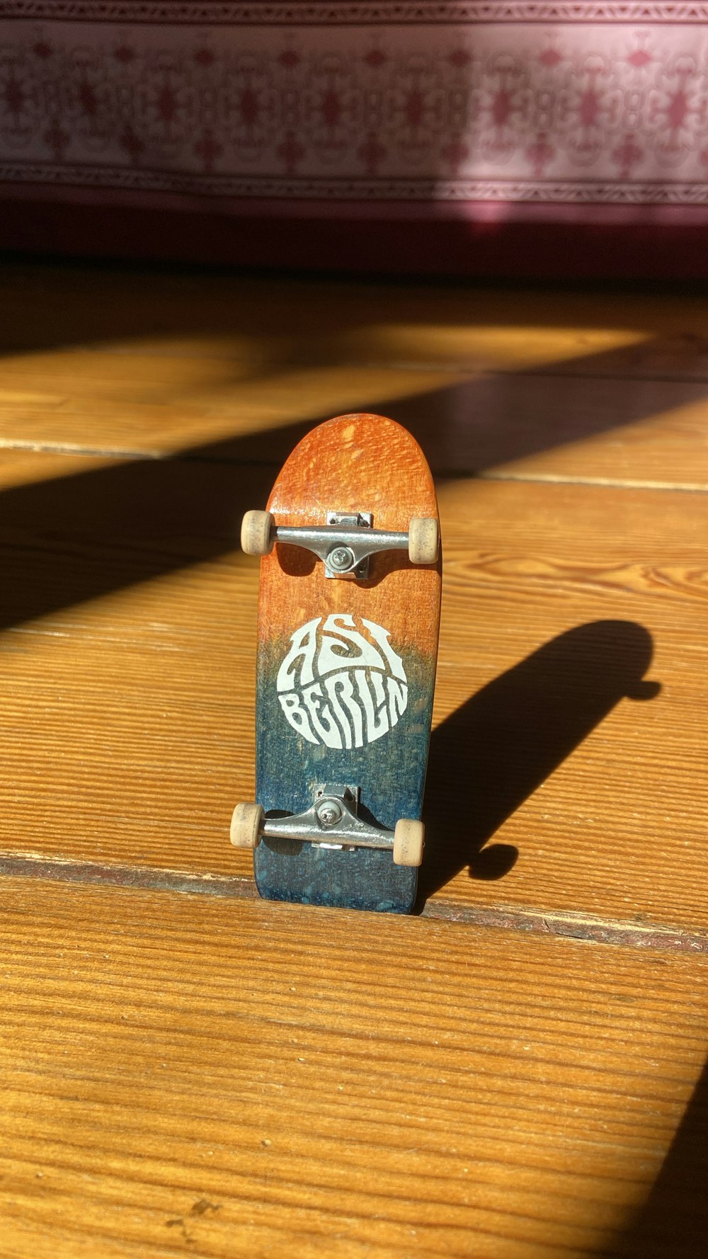 a skateboard sitting on top of a wooden floor