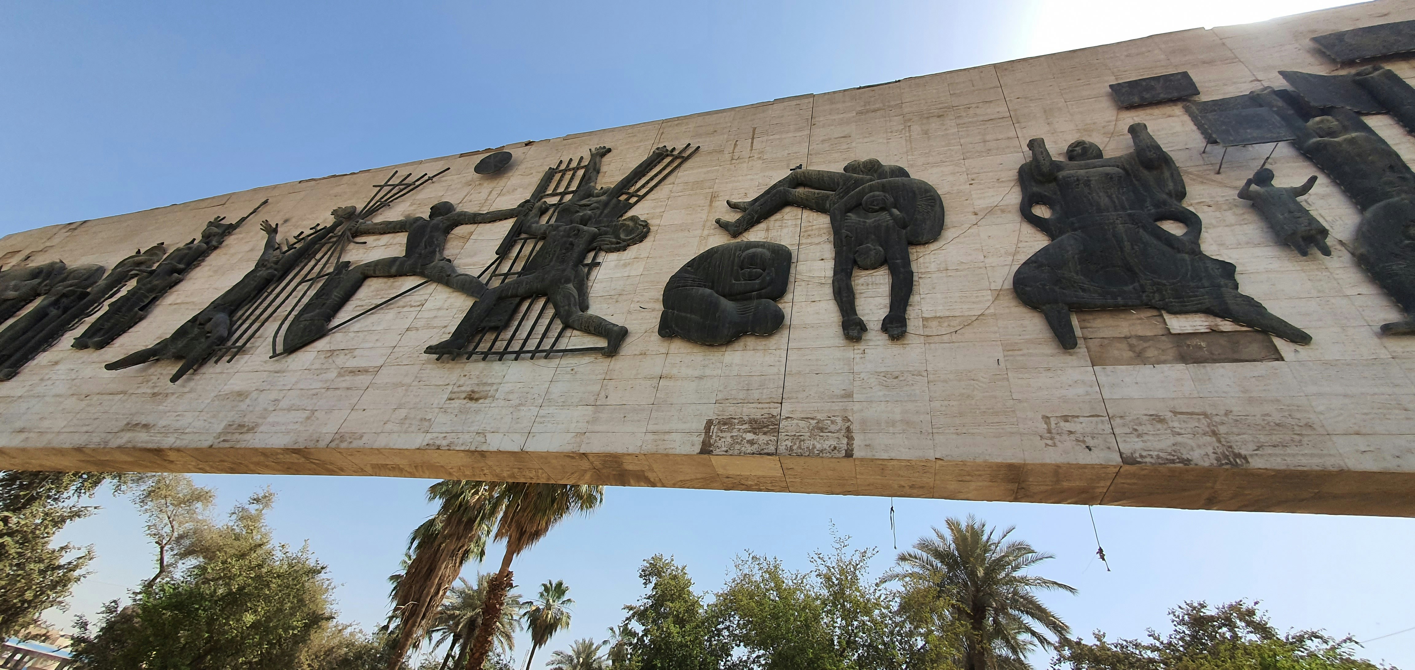 a large sign that has a bunch of statues on it