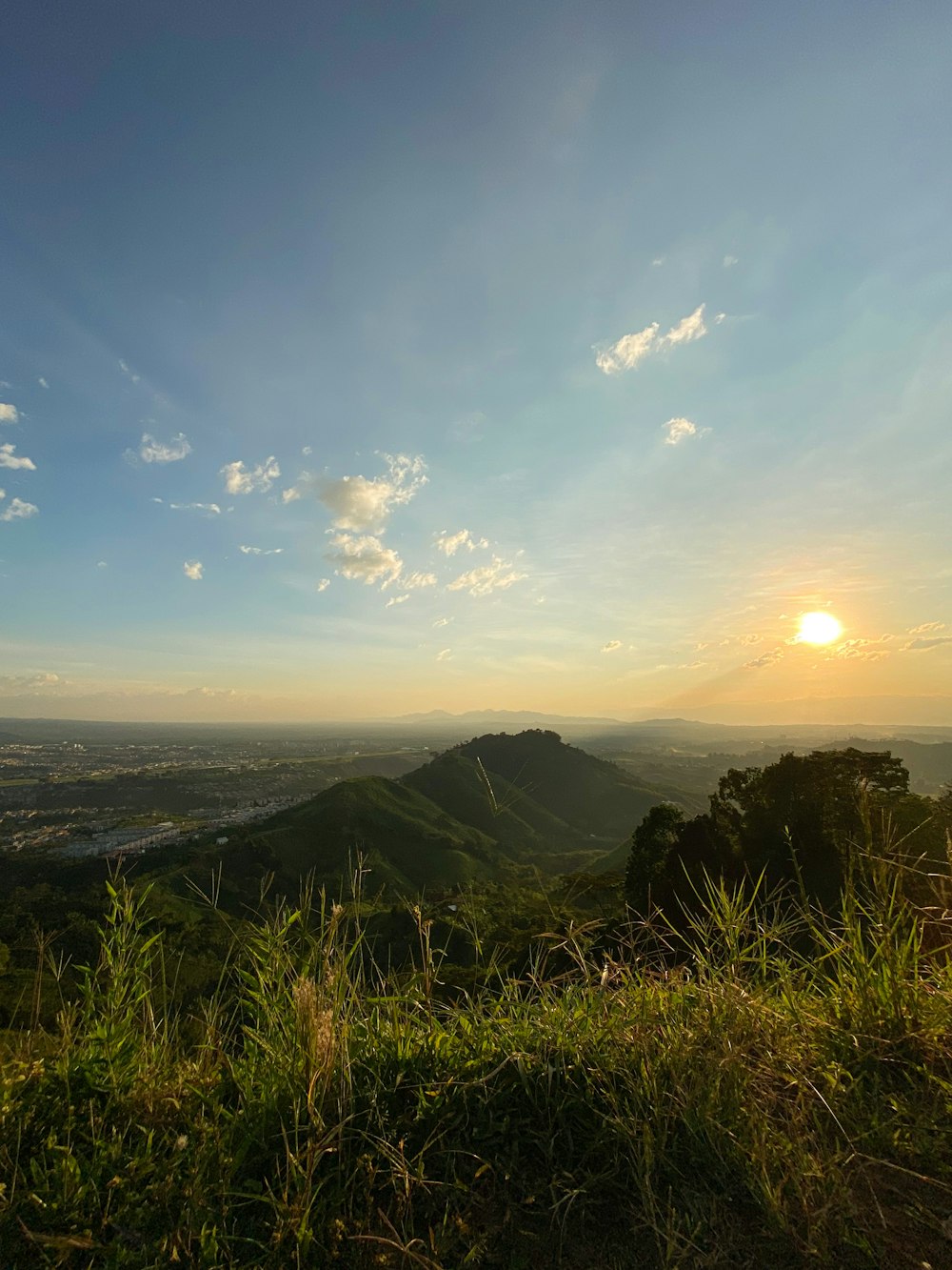 the sun is setting over a mountain range