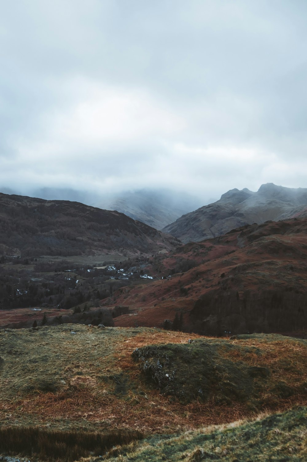 a view of a valley with mountains in the background