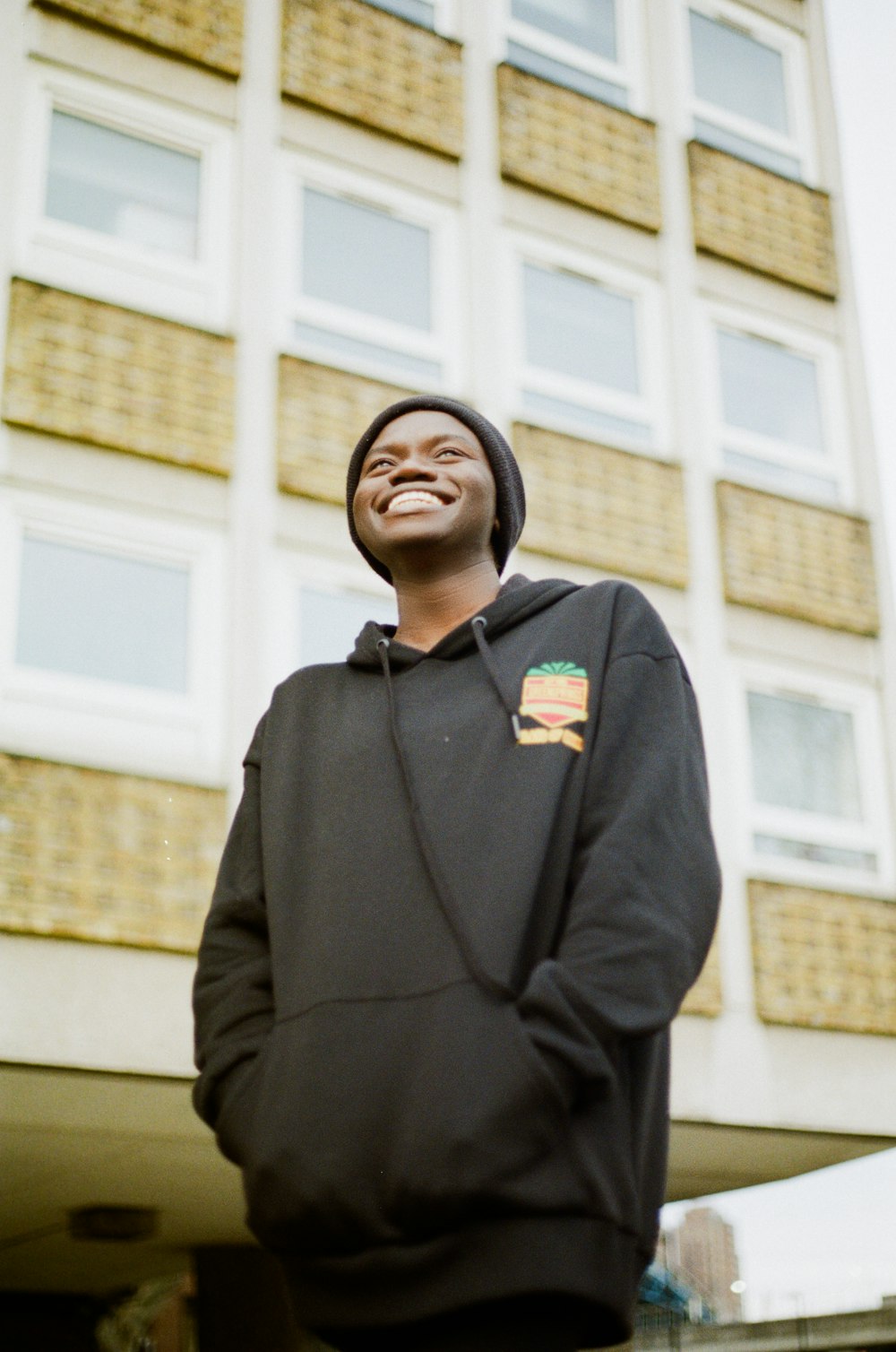 a man standing in front of a tall building