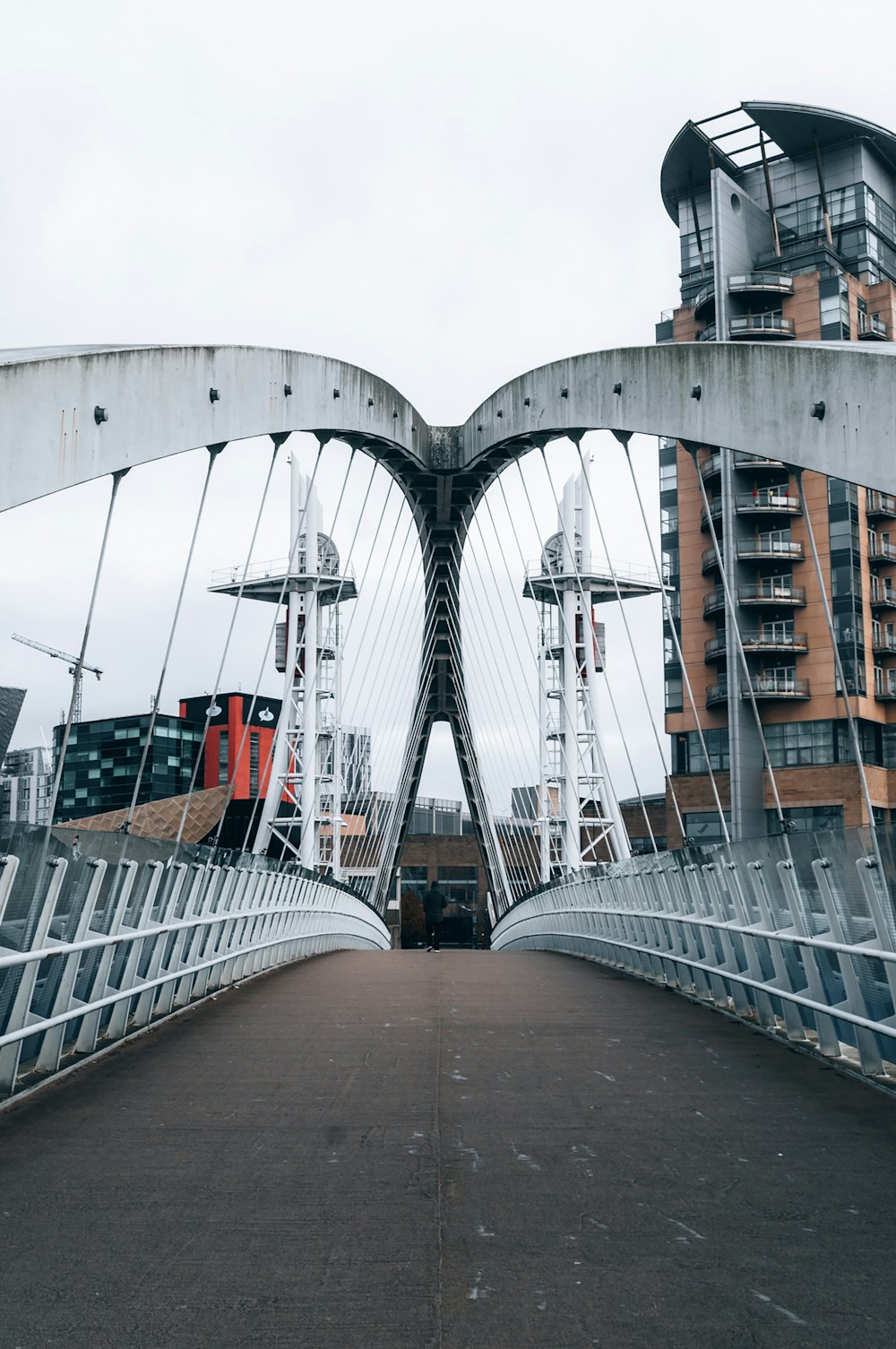 a bridge that has a very tall building in the background