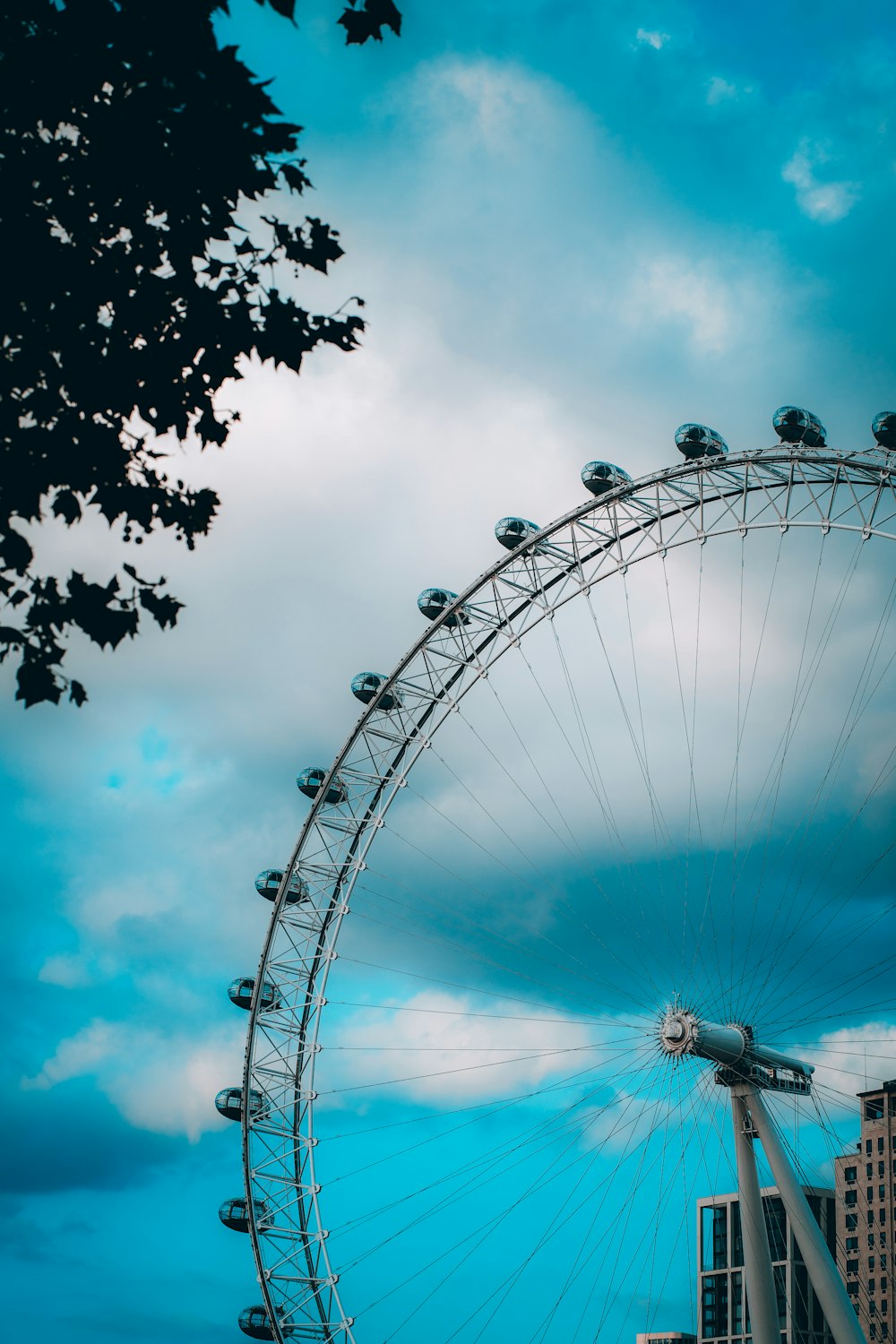 a large ferris wheel sitting next to a tall building