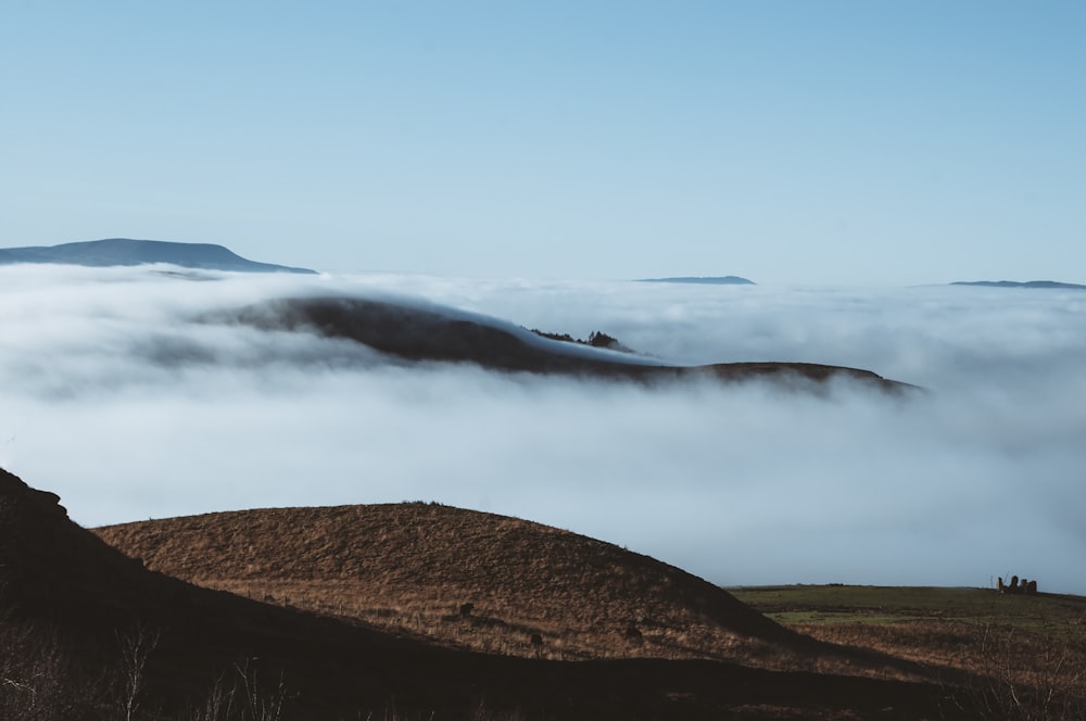 a hill covered in fog and low lying clouds