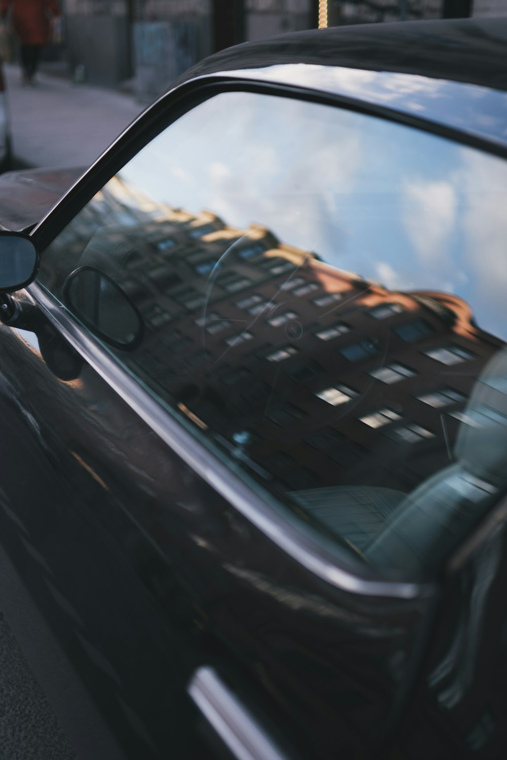 a black car parked on the side of a street