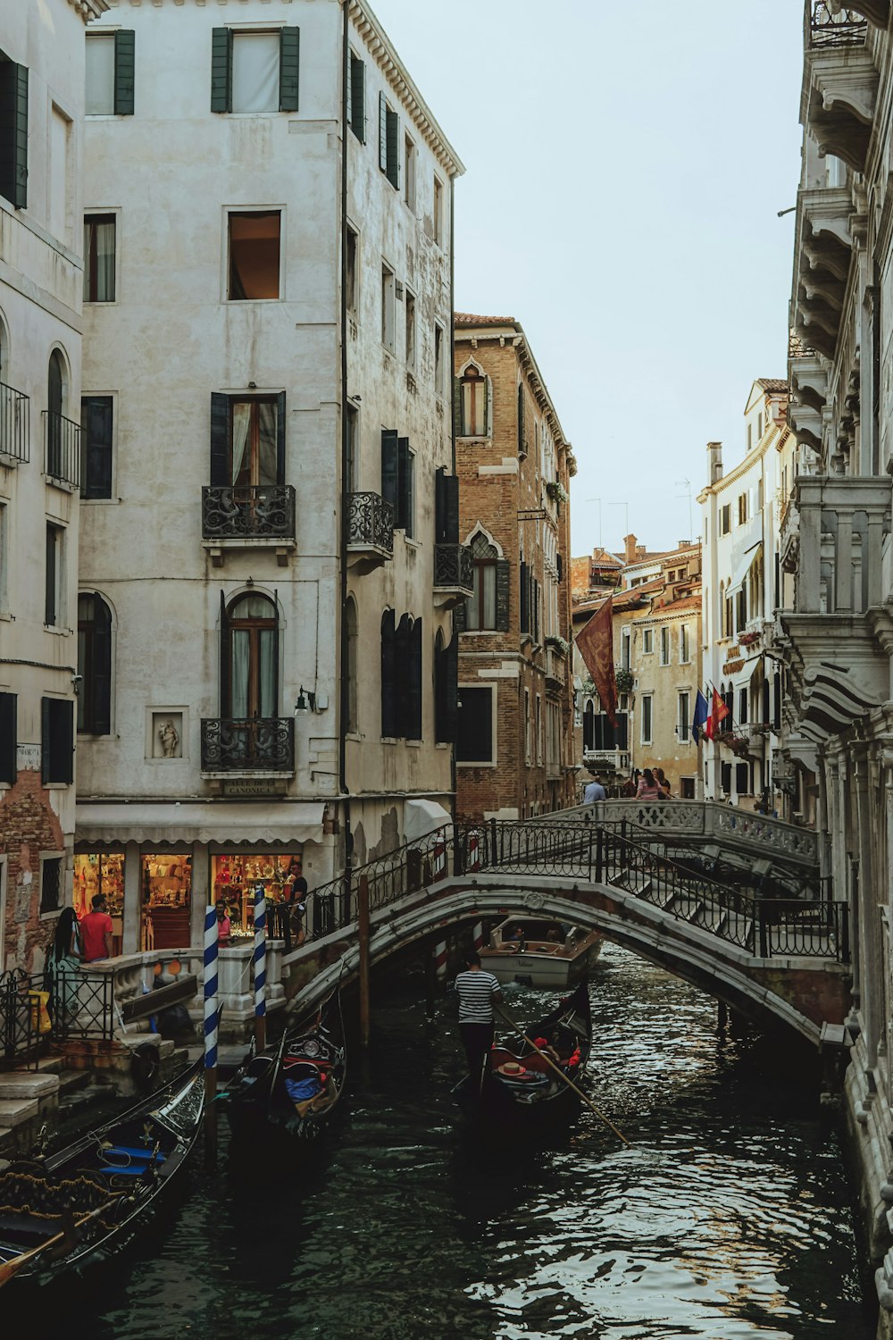 a small bridge over a small canal in a city