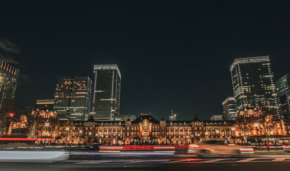 a night time view of a city with tall buildings