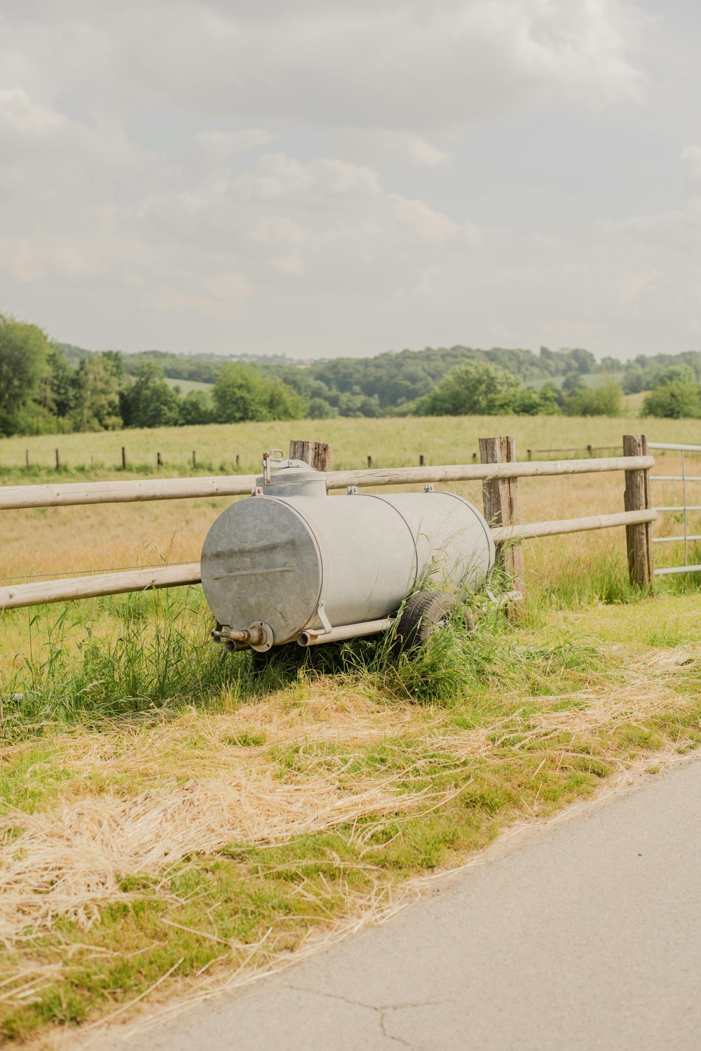 a large metal tank sitting in the middle of a field