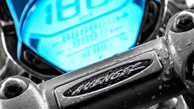Close-up of a Yamaha bike's dashboard illuminated under Bogotá's city lights.