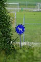 a blue sign with a white dog on it