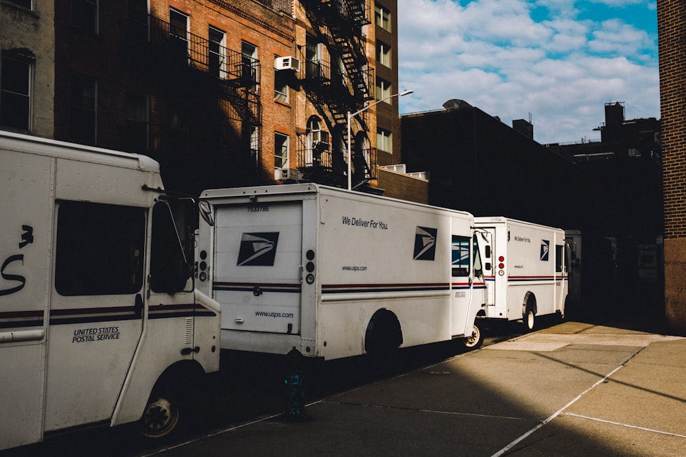 a row of delivery trucks parked next to each other