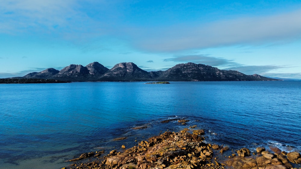 a large body of water with mountains in the background