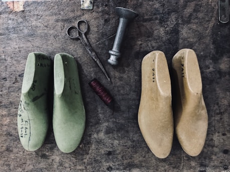 a pair of shoes and a pair of scissors on a table
