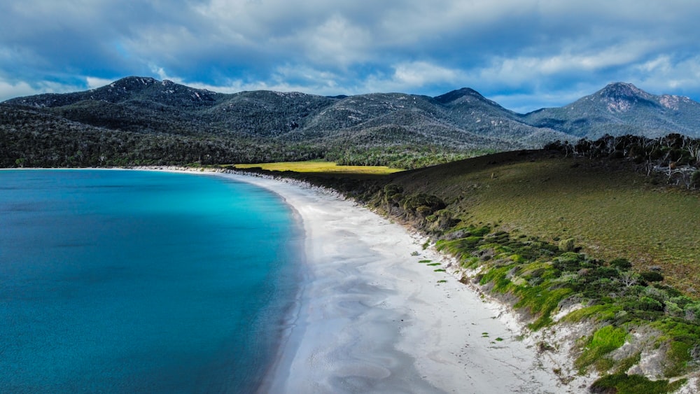 an aerial view of a beach and mountains