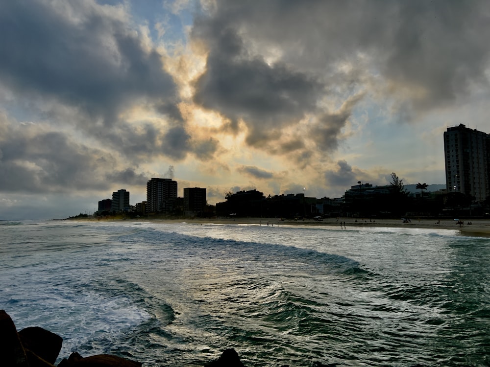 a view of a beach with buildings in the background