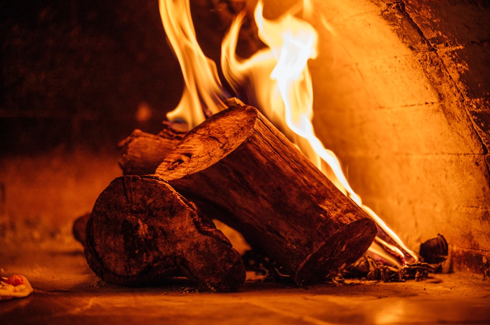 a fire burning in a fireplace with logs