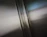 Close-up of a glossy metallic epoxy garage floor reflecting natural light.