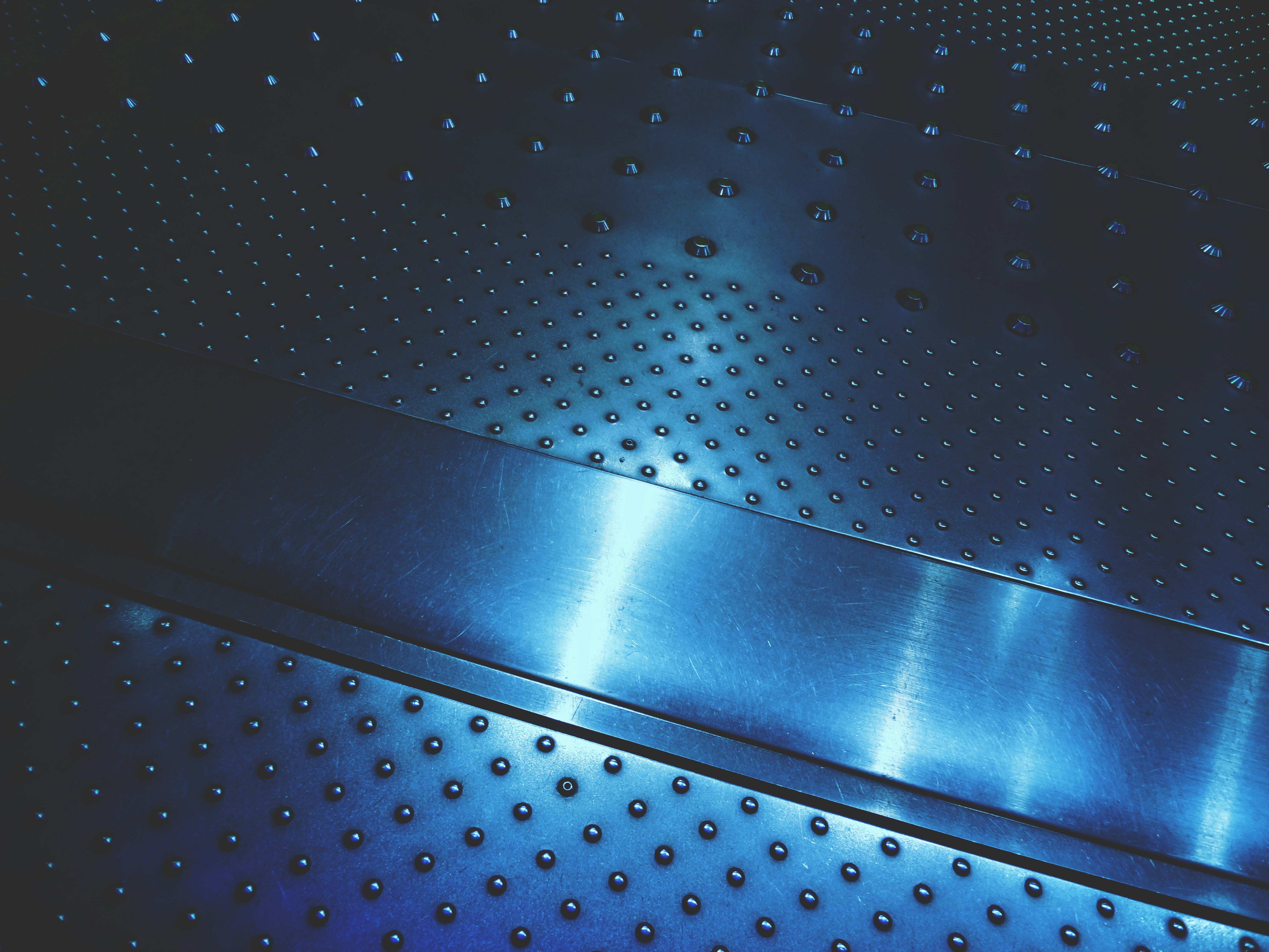 a close up of a metal surface with rivets