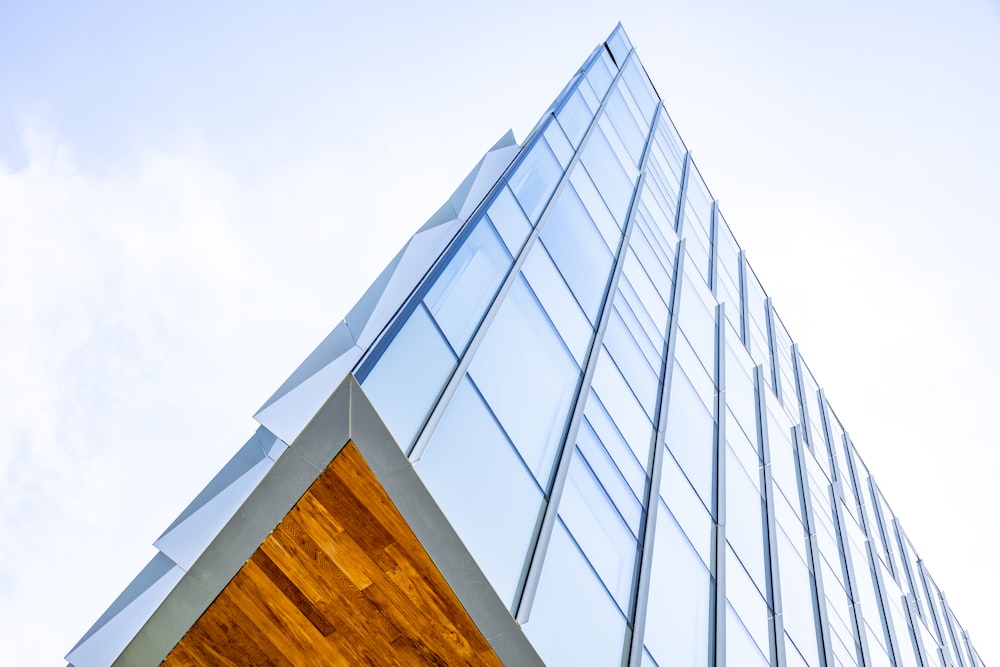 a tall glass building with a wooden door