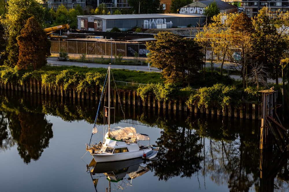 a small sailboat floating on top of a body of water