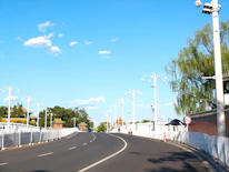 Wide, clean internal roads lined with streetlights in the gated community.