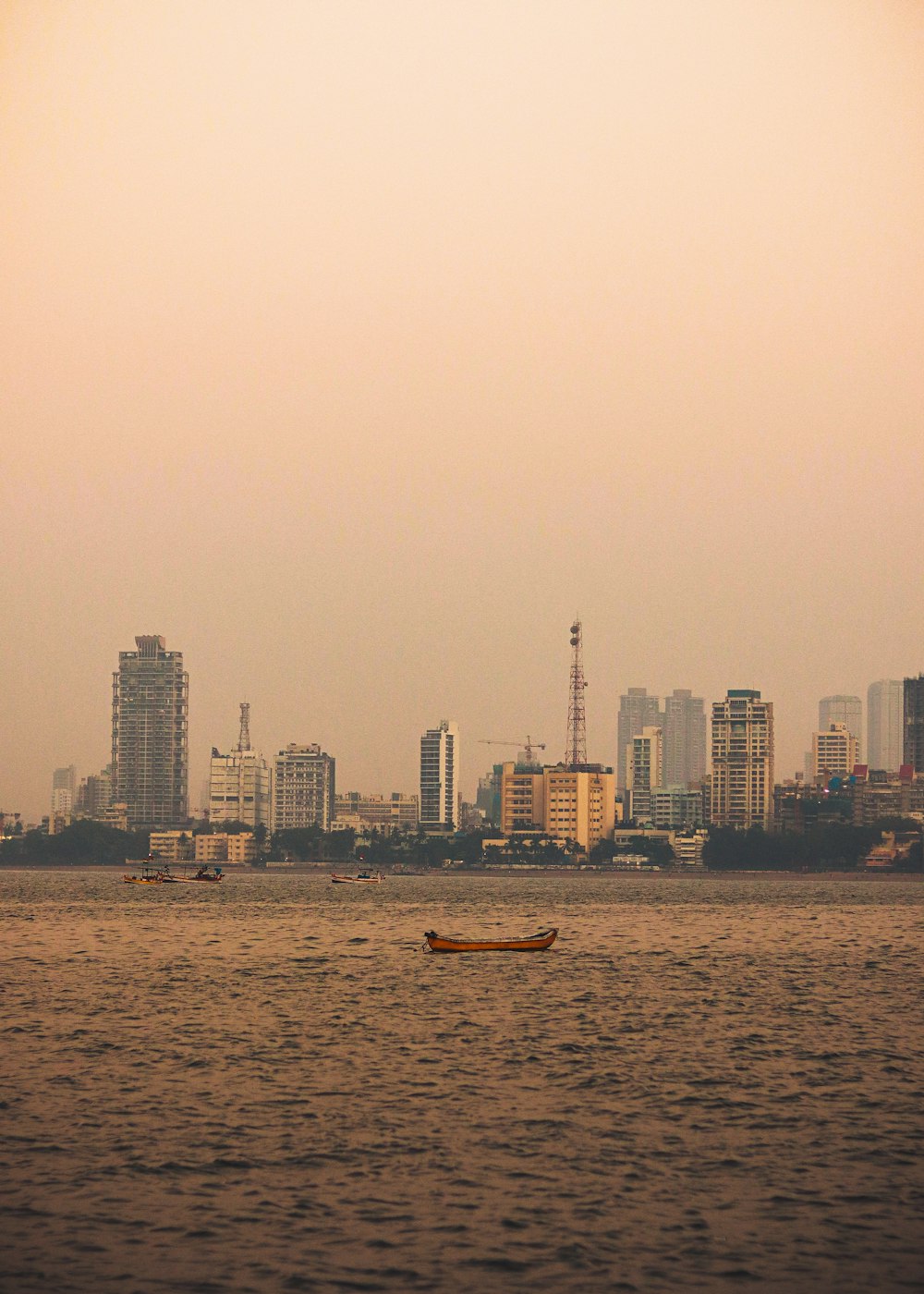 a large body of water with a city in the background