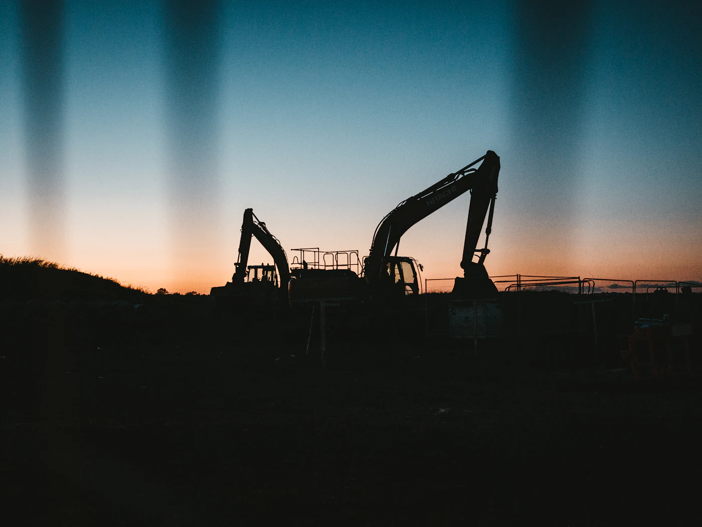 Excavator at work on a construction site at dusk