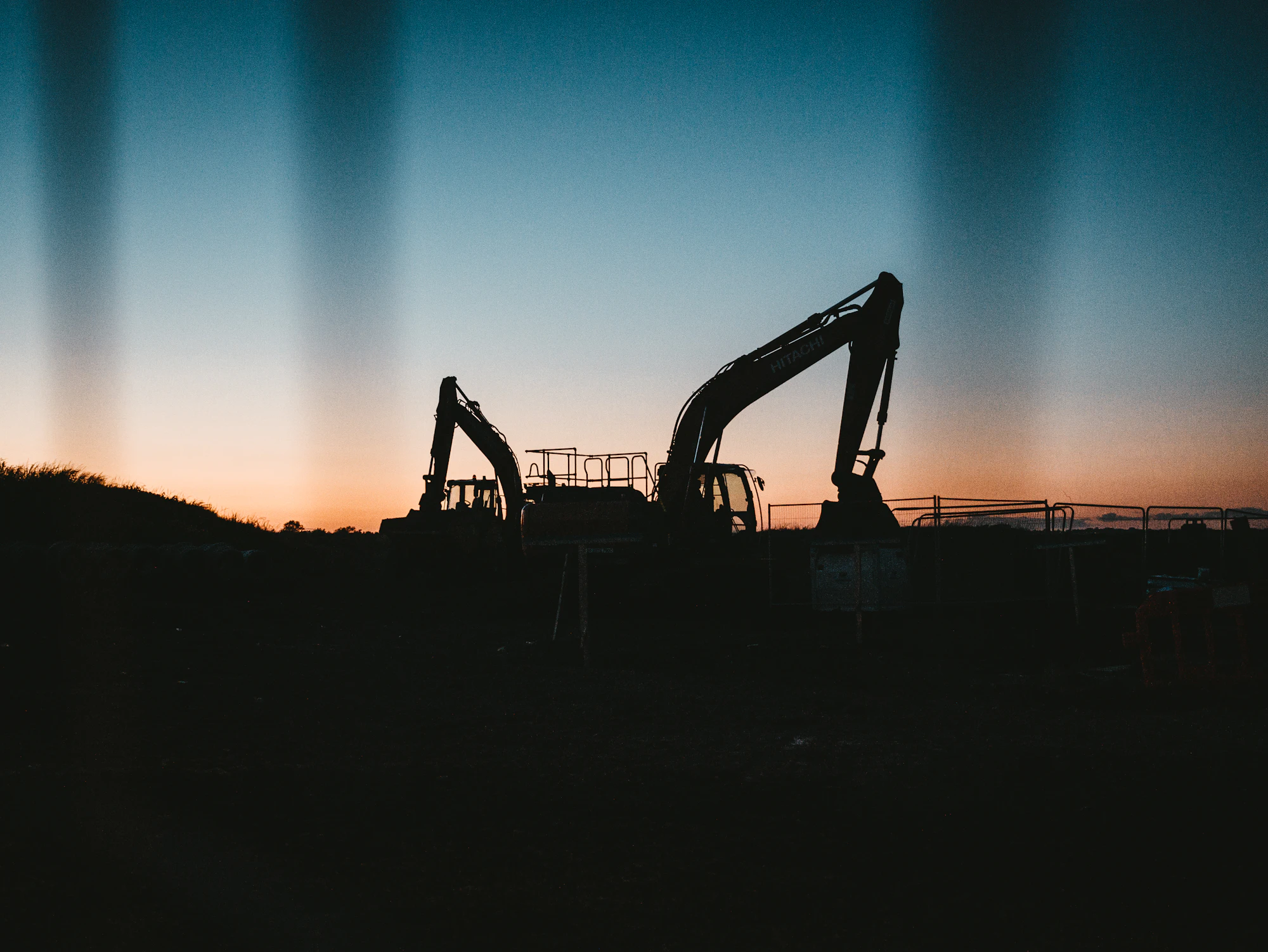 Excavator silhouetted against the sky at a construction site