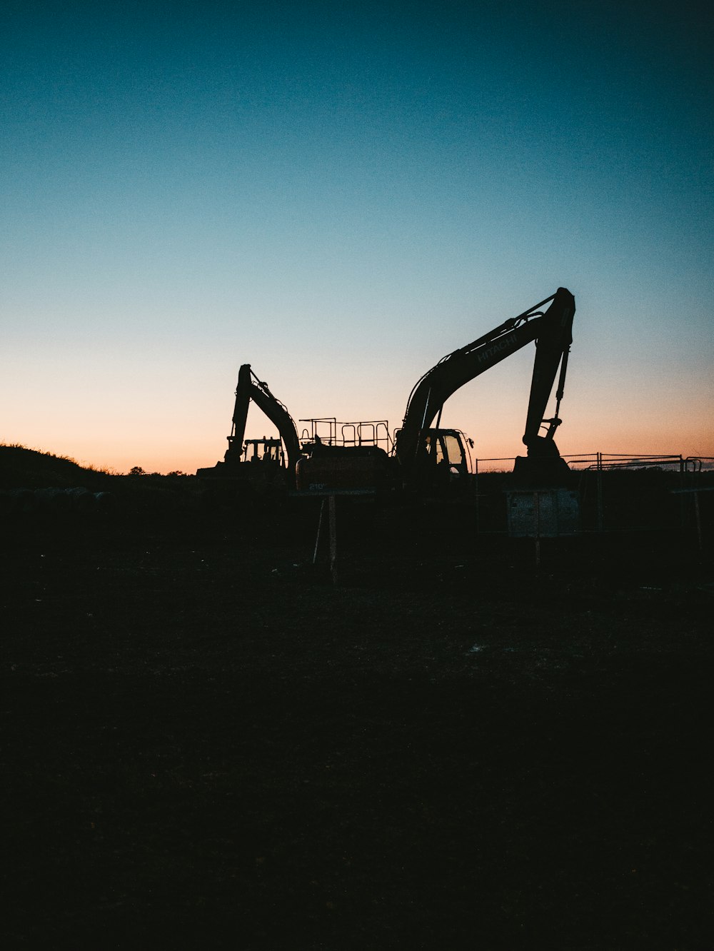 a couple of large machines sitting on top of a field