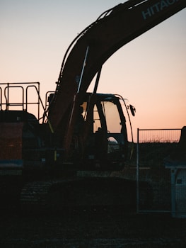 a large construction vehicle sitting in the middle of a field