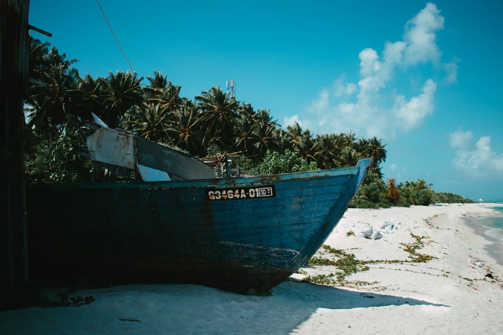 a boat sitting on top of a sandy beach