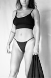 a black and white photo of a woman in a bikini
