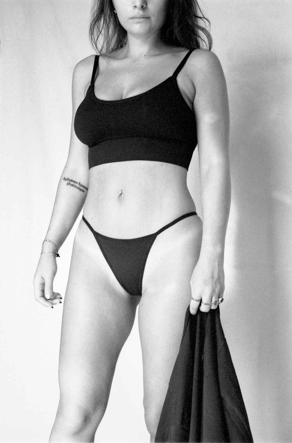 a black and white photo of a woman in a bikini