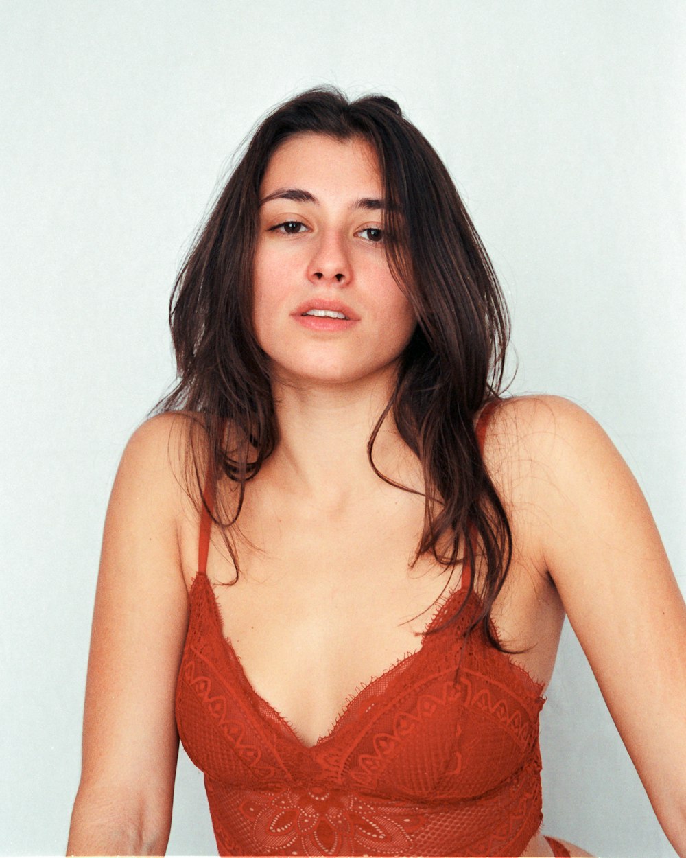 a woman in a red bra posing for a picture