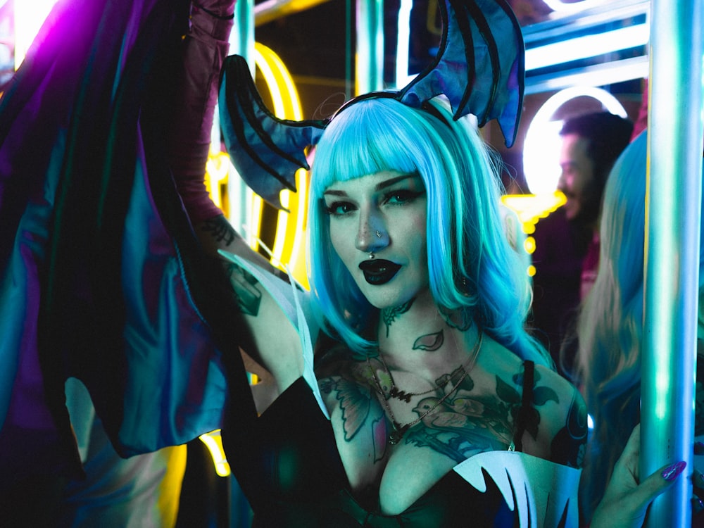 a woman with blue hair and horns on her head