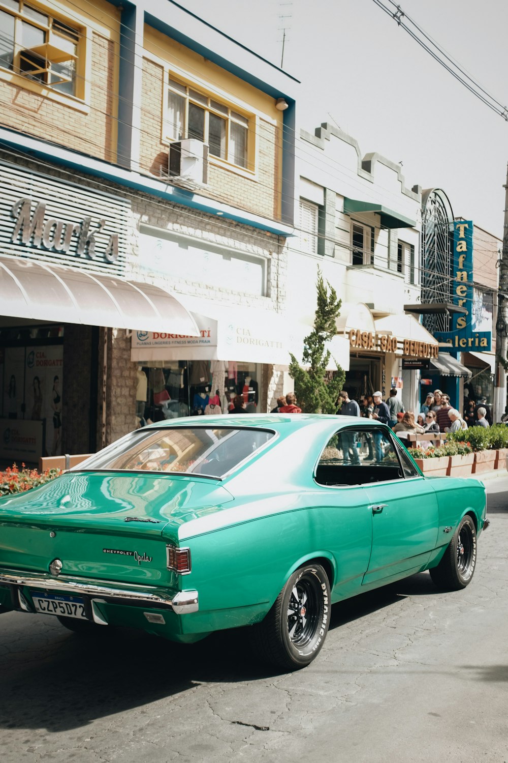 a green car parked on the side of the road