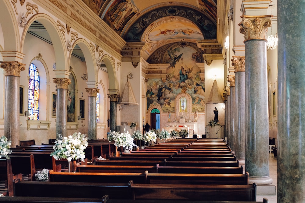 a church filled with pews and decorated with flowers