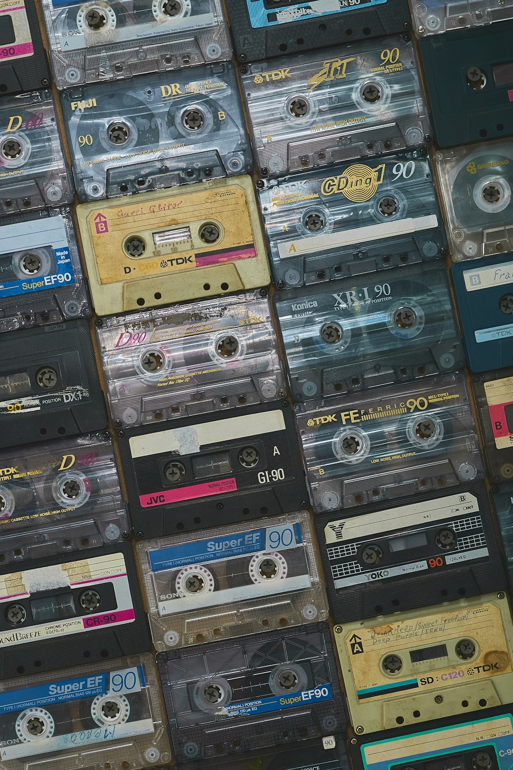 a wall of old cassettes are stacked on top of each other
