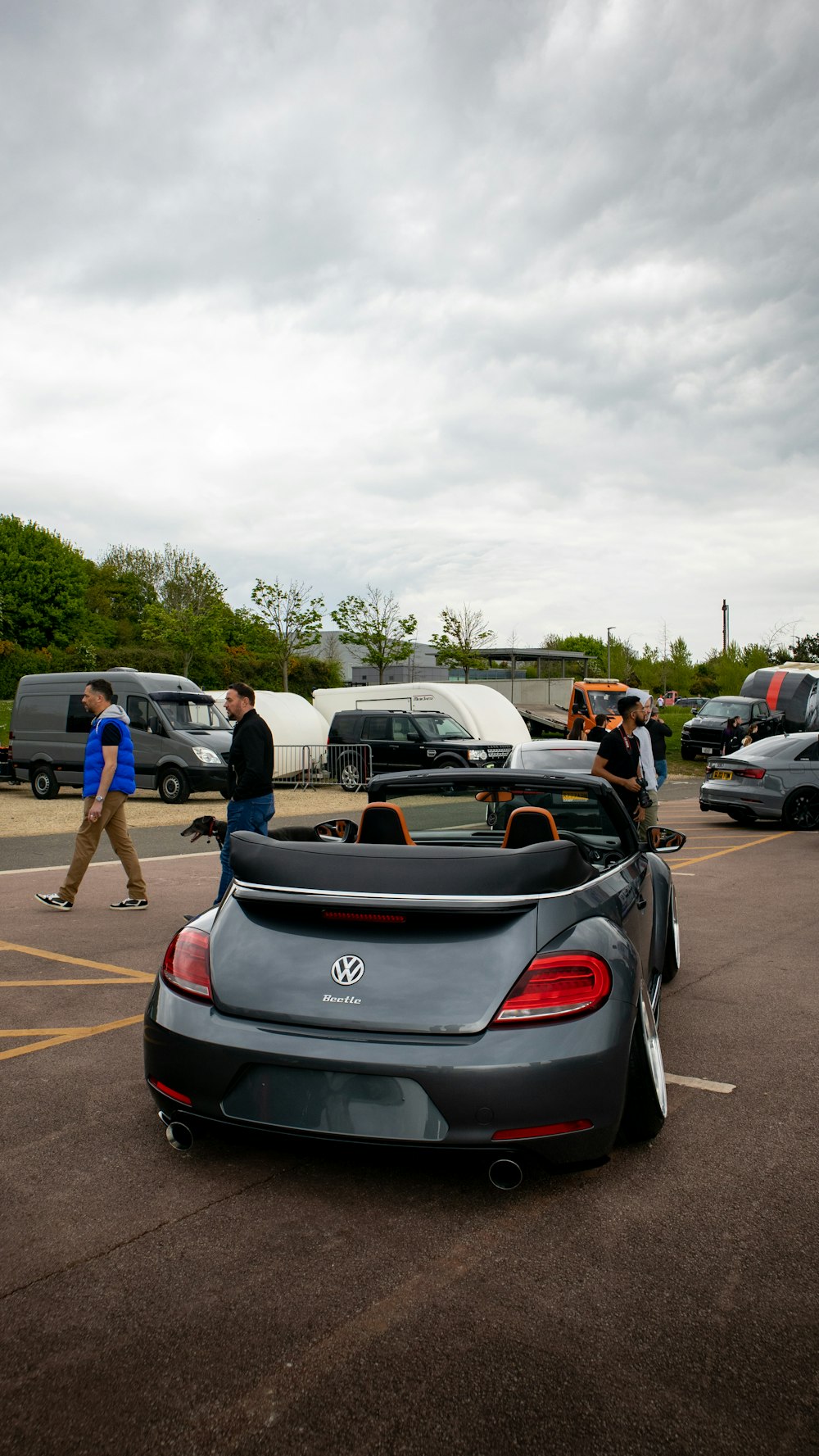 a car parked in a parking lot next to other cars