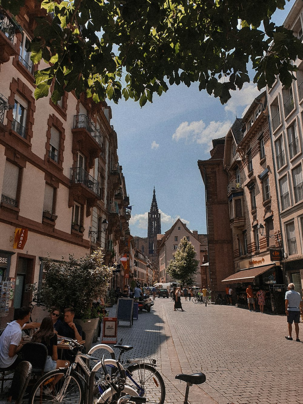 a group of people sitting at tables on a street